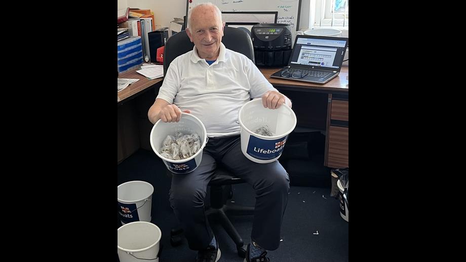 Man at desk with donation buckets