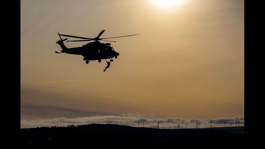 Man hanging from helicopter