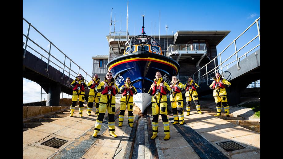 Shoreham Harbour Crew standing on the slipway in front of the all-weather lifeboat