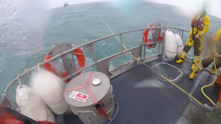 Lifeboat crew managing out sufficient line having established the tow