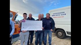 Representatives pictured in the handing over funds raised.