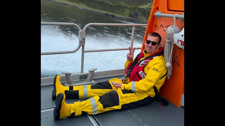 Crew member Adam MacDonald pictured on the deck of Portree lifeboat in less challenging times!