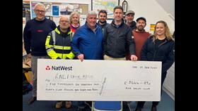Group of people with large cheque