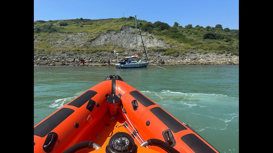 Littlestone lifeboat sitting offshore watching a grounded yacht as she refloats