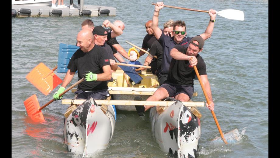 8 men paddling a raft