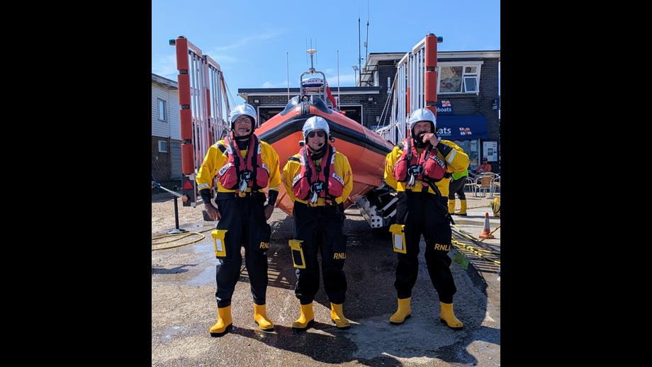 Crew members in bright yellow RNLI dry suits