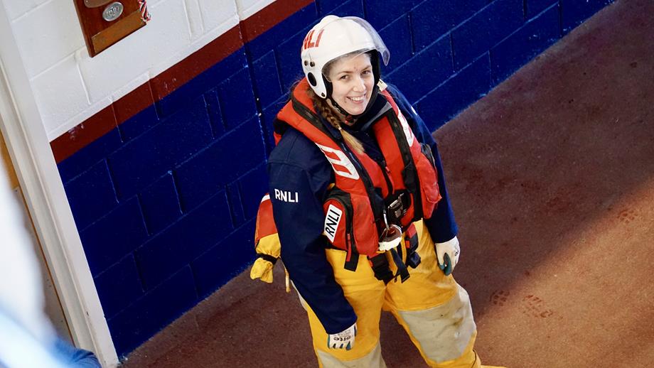 Cromer RNLI Demi Trenholm in boathouse wearing RNLI helmet and Kit 