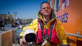 Lewis Arnold along side Newhaven RNLI's Severn class ALB