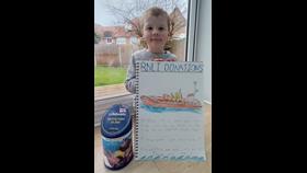Grey holding his latest fundraising poster 