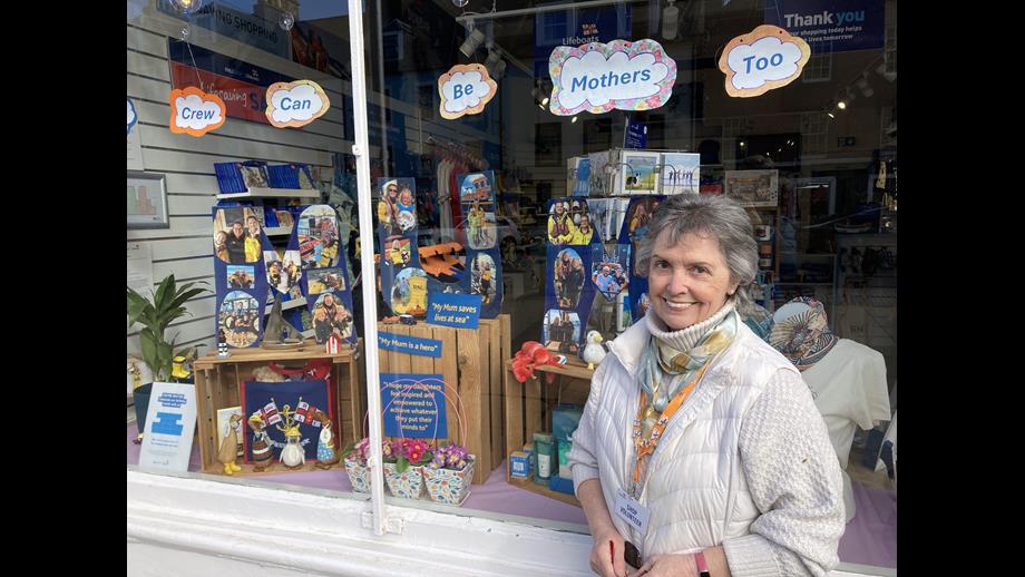 Woman outside shop.