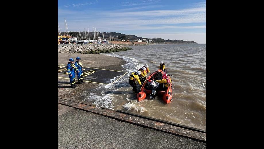 West Kirby Lifeboat crew returning to shore with casualties with Coastguard team awaiting onshore