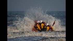 Volunteers from Bridlington RNLI heading out to sea on the inshore lifeboat.