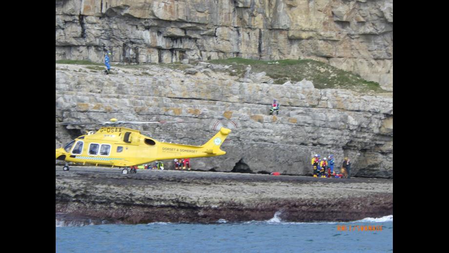 Dorset and Somerset Air Ambulance landed at Dancing Ledge preparing to evacuate casualty