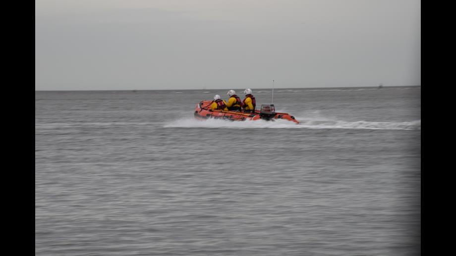 Wells RNLI inshore lifeboat on cut of by the tide rescue with a volunteer crew of three