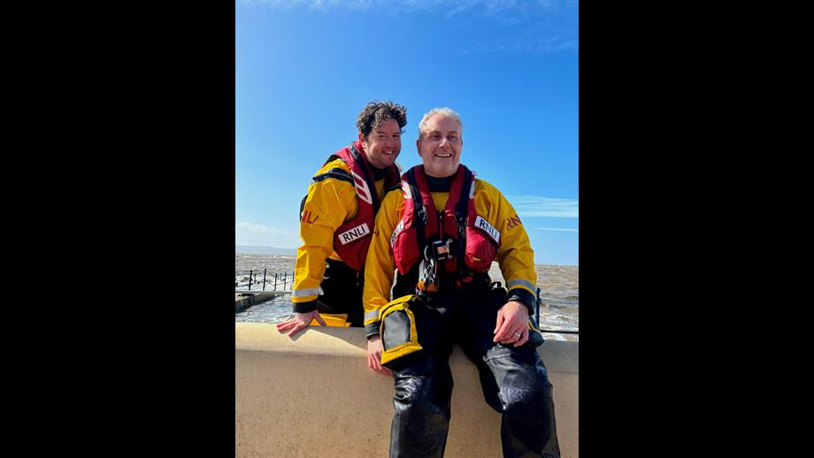 Two West Kirby Helms are sitting on the lake wall as they come back to the station after the callout