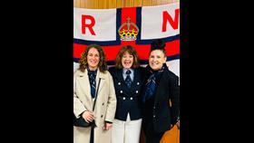 (L-R) RNLI volunteers Sara Sidall - Penarth Fundraising, Avril Kitchen Fundraising Lead Barry Dock and Caroline stood in front of RNLI flag.
