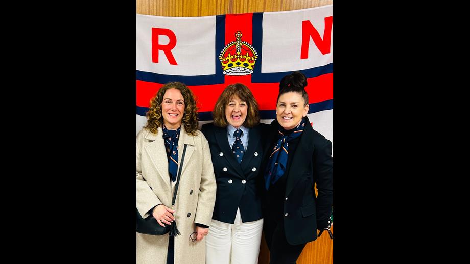 (L-R) RNLI volunteers Sara Sidall - Penarth Fundraising, Avril Kitchen Fundraising Lead Barry Dock and Caroline stood in front of RNLI flag.