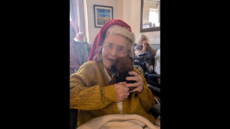 Anita Twine with her RNLI teddy from Wells RNLI on her 105th birthday. Anita cuddling her tedding in her Christmas hat