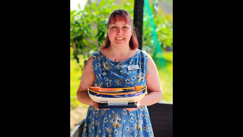Marsha Hughes at Thorp House care home with RNLI charity box
