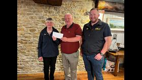 Fundraising Treasurer, Margaret Gill ; Coxswain, Aonghus O Hiarnain being presented a cheque from Brendan Gaynor, Organiser of Classic Car Run