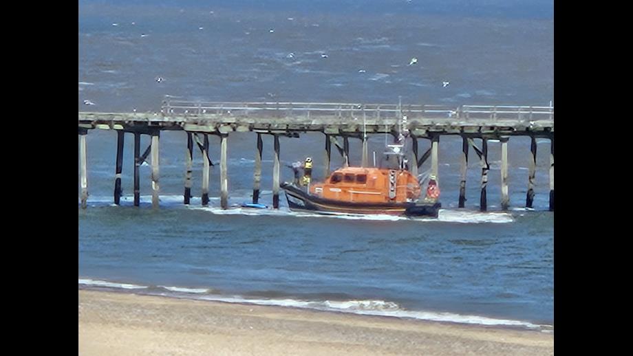 Lowestoft RNLI Lifeboat rescuing a paddle boarder