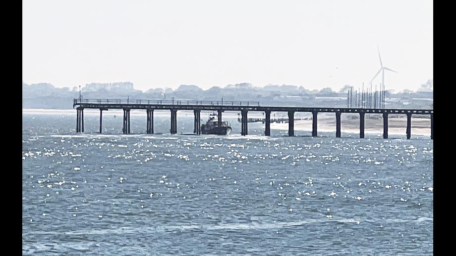 Lowestoft RNLI Lifeboat rescuing a paddle boarder from under Claremont Pier