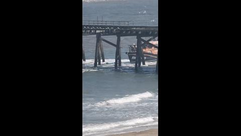 Lowestoft RNLI Lifeboat rescuing a paddle boarder from under Claremont Pie