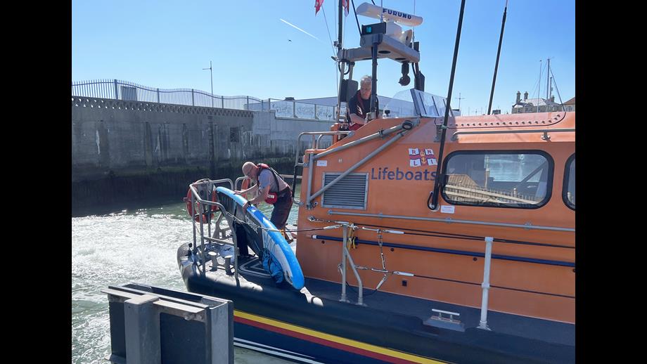 Lowestoft RNLI Lifeboat crew return to their mooring after rescuing a paddle boarder from under Claremont Pier