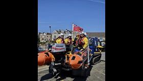 The crew can be seen on the D class lifeboat after it had been recovered on the slipway