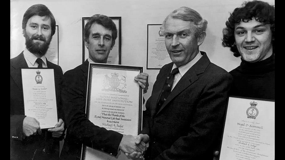 Brian Hadler (left) along with Mike Judge Snr and Nigel Scammel are presented awards for the service to the catamaran 'Rumpleteezer' in 1981 by Admiral Wilf Graham director of the RNLI.