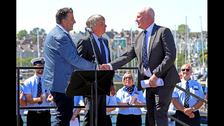 Richard and Jason Clarke pictured handing the lifeboat into the care of the RNLI with Trustee Paddy McLaughlin accepting.