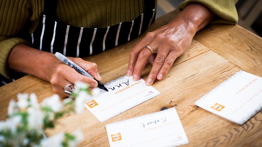 Close up of woman's hands writing table settings
