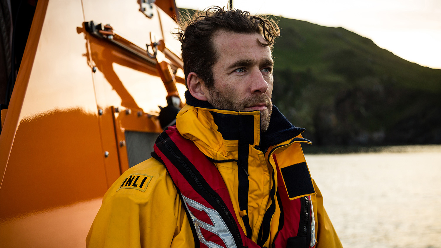 Crew member on a lifeboat looking out to sea. Photo: RNLI