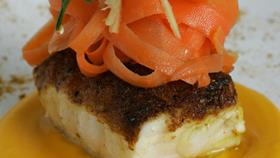 Monkfish served on a carrot and orange purée with a ginger and carrot salad