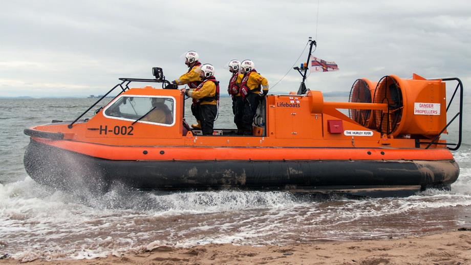 RNLI Morecanbe's hovercraft Hurley Flyer H-002 launching across the sand.