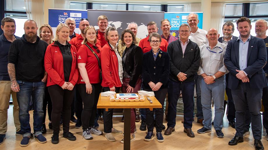 A group photo of people from the RNLI, IMRF, and international search and rescue organisations including the Netherlands, Norway, France, Iceland and Uruguay at the Lifeboat Festival in Poole, Dorset, in May 2024 
