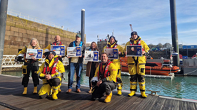 RNLI Jersey crew with Jersey Post members launching new stamps