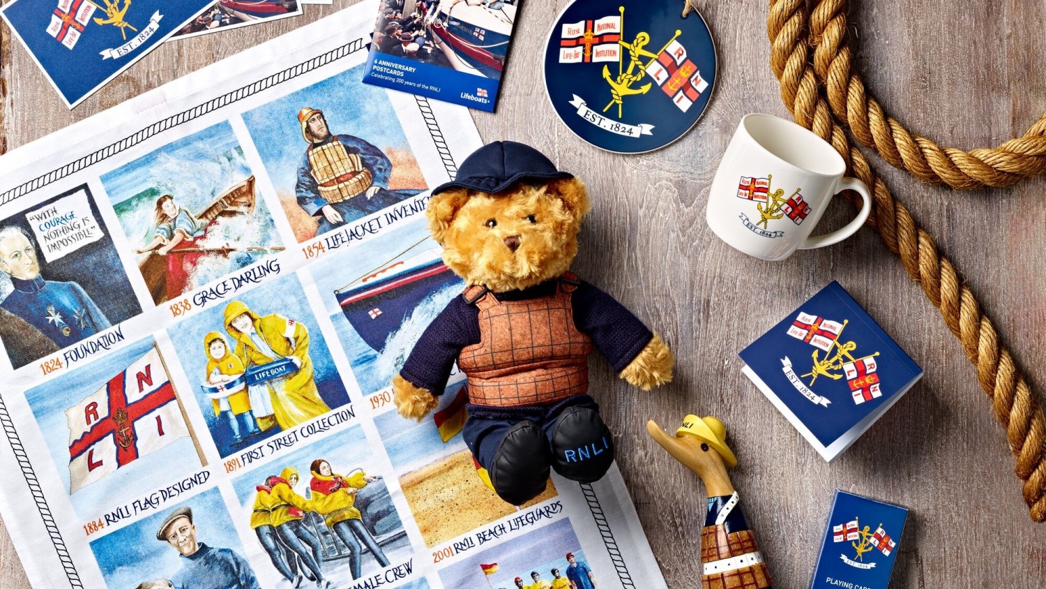 A selection of RNLI 200 gifts on a wooden background