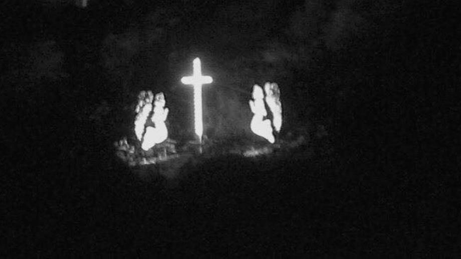 The cross and angels at Mousehole shining across the village and out to sea in memory of the lives lost in the Penlee lifeboat disaster in 19981