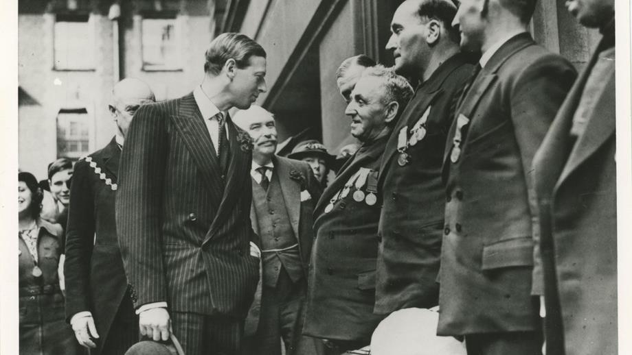 Black and white image of crew meeting HRH Prince George, Duke of Kent