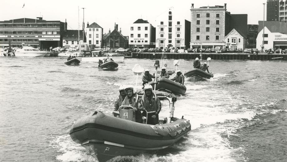 Black and white image of five inshore lifeboats