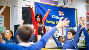 A female RNLI Education volunteer giving prevention and safety advice to the children of Coldfall primary School in London. 