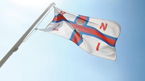 RNLI Flag flying with blue skies