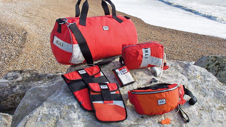 Our range of products made from upcycled red lifejackets, including a tablet case, wash bag, wallet, bumbag and duffel bag.