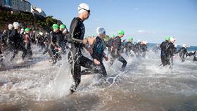 Fundraisers running into the sea at Tenby
