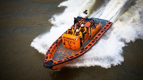 Tower crew onboard their E class lifeboat, Hurley Burly E-07, on the River Thames