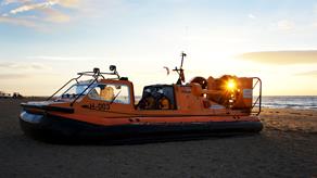 Hunstanton lifeboat volunteers onboard their rescue hovercraft, The Hunstanton Flyer H-003, at sunset