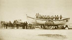 Historical image of Falmouths first lifeboat, being pulled by horses.