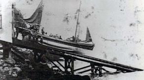 Image of Little and Broadhaven's first lifeboat launching down a slipway, black and white