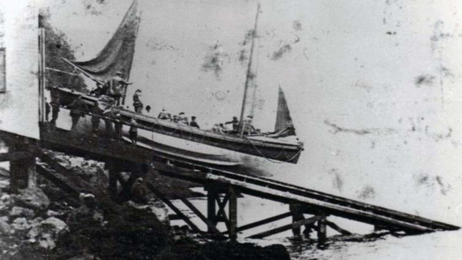Image of Little and Broadhaven's first lifeboat launching down a slipway, black and white